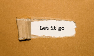The text Let it go appearing behind torn brown paper The text Let it go appearing behind torn brown paper